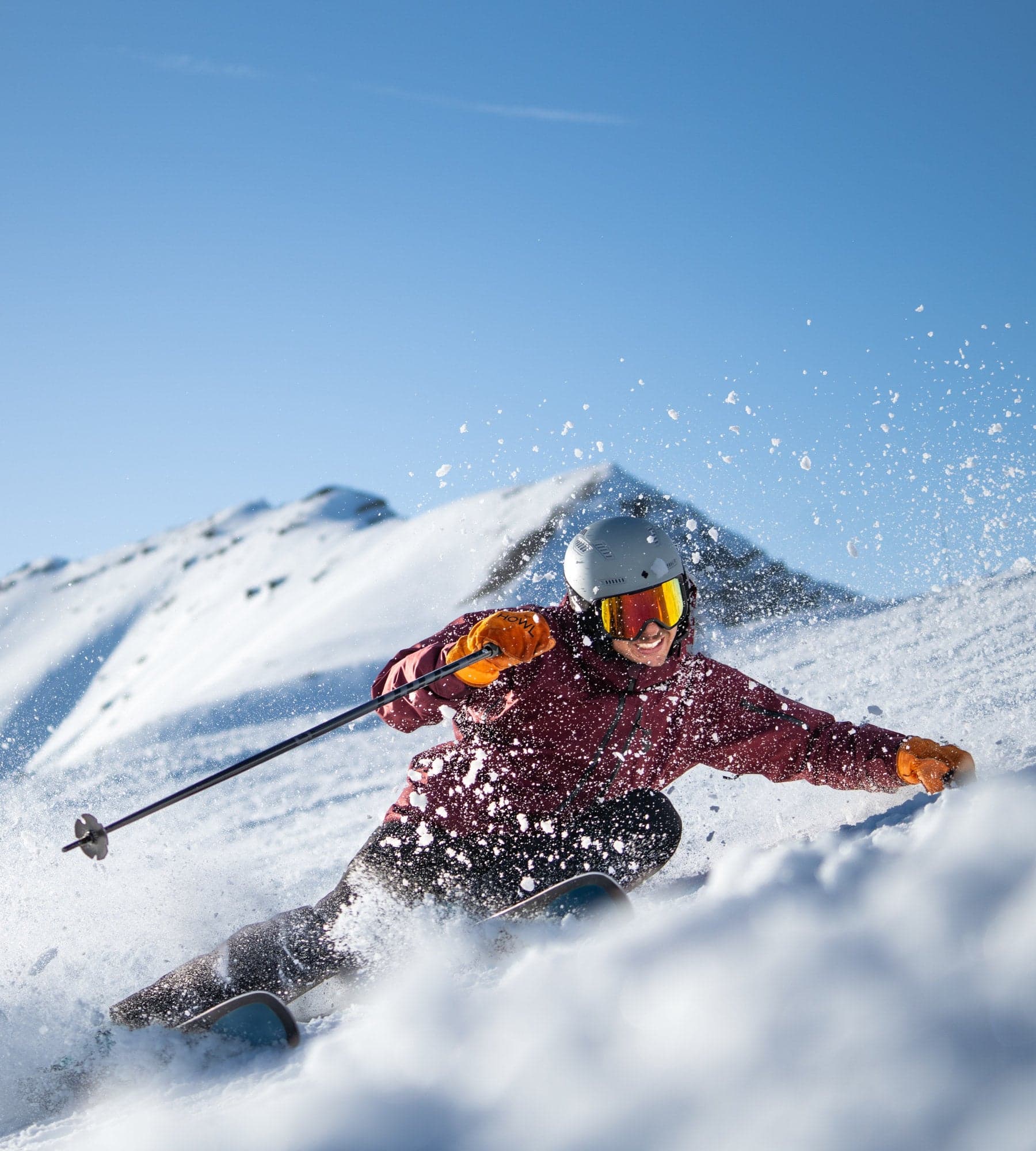 Skier driving through fresh snow on Kästle skis